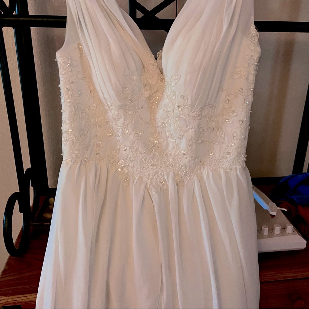 Beautiful wedding dress, never worn, intricate detail. Size 7.
